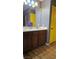 Bathroom with a double sink vanity, wood floors and a yellow door at 4928 Indigo Gorge Ave, Las Vegas, NV 89131