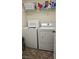 Laundry room with washer, dryer, shelving, and tiled floor at 4928 Indigo Gorge Ave, Las Vegas, NV 89131