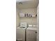 Practical laundry room with a washer, dryer, and shelf space for storage at 4928 Indigo Gorge Ave, Las Vegas, NV 89131