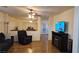 Comfortable living room with hardwood floors, fireplace, and views into the dining room at 4928 Indigo Gorge Ave, Las Vegas, NV 89131