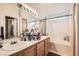 Bathroom featuring double sinks and a shower-tub combo at 5022 Arizo Ct, North Las Vegas, NV 89031