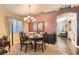 Bright dining area with a chandelier, a large window, and an open layout, perfect for Gathering gatherings at 5022 Arizo Ct, North Las Vegas, NV 89031