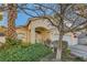 Inviting single-story home with desert landscaping and mature palm trees under a clear blue sky at 5022 Arizo Ct, North Las Vegas, NV 89031