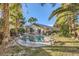 Lush backyard featuring a private pool, complemented by mature landscaping and patio seating at 5022 Arizo Ct, North Las Vegas, NV 89031