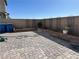 Spacious backyard with a brick-paved patio, raised garden bed, and a privacy wall at 5161 Birchland Manor Ave, Las Vegas, NV 89139