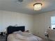 Bedroom featuring a modern ceiling light, and a plush headboard with decor at 5161 Birchland Manor Ave, Las Vegas, NV 89139