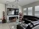 Cozy living room with stone fireplace, large tv and leather sectional sofa at 5161 Birchland Manor Ave, Las Vegas, NV 89139