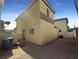 Spacious backyard with a partially gravelled area, fence, and house exterior at 5212 Paradise Skies Ave, Las Vegas, NV 89156