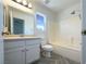 Bright bathroom with white cabinets, a large mirror, tub, and natural light from a window at 5212 Paradise Skies Ave, Las Vegas, NV 89156