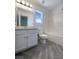 Clean bathroom featuring white fixtures, a tub-shower combo, and modern flooring at 5212 Paradise Skies Ave, Las Vegas, NV 89156