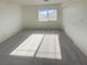 Bright, empty bedroom with neutral carpet, large window, and closet space at 5212 Paradise Skies Ave, Las Vegas, NV 89156