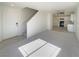 Inviting living room featuring a staircase, neutral walls, and leading into a kitchen at 5212 Paradise Skies Ave, Las Vegas, NV 89156