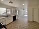 Open-concept living room with modern flooring flowing into the kitchen area at 5212 Paradise Skies Ave, Las Vegas, NV 89156