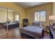 Cozy bedroom features wood floors, natural light and a mirrored closet at 5250 S Rainbow Blvd # 1121, Las Vegas, NV 89118