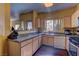 Kitchen with granite counters, wooden cabinets, and modern appliances at 5250 S Rainbow Blvd # 1121, Las Vegas, NV 89118