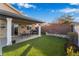 Backyard view with artificial grass, patio and outdoor furniture. Perfect for outdoor entertaining at 58 Desert Sunflower Cir, Henderson, NV 89002