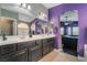 Stylish bathroom featuring double vanity, soaking tub, and arched doorways at 58 Desert Sunflower Cir, Henderson, NV 89002