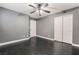 Bedroom with dark wood floors, gray walls, closet and a doorway to another room at 58 Desert Sunflower Cir, Henderson, NV 89002