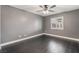 This bedroom features dark wood floors, gray walls, white trim and plantation shutters for bright natural light at 58 Desert Sunflower Cir, Henderson, NV 89002