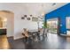 Bright dining room features dark floors, modern decor, and sliding glass doors to the backyard at 58 Desert Sunflower Cir, Henderson, NV 89002