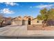 Charming single-story home with a three-car garage, desert landscaping, and a well-maintained lawn at 58 Desert Sunflower Cir, Henderson, NV 89002