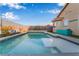 Backyard pool view featuring a clear blue sky and the reflection of the house in the pool water at 58 Desert Sunflower Cir, Henderson, NV 89002