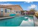 Backyard pool with house reflection, clear blue sky, patio and outdoor furniture at 58 Desert Sunflower Cir, Henderson, NV 89002