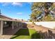 Expansive backyard featuring gravel, artificial turf, garden beds, and mature landscaping at 60 Reyburn Dr, Henderson, NV 89074