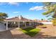 Beautiful backyard with an expansive covered patio, gravel, and artificial turf at 60 Reyburn Dr, Henderson, NV 89074