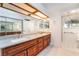 Bathroom features a double sink vanity with granite countertops, lots of storage, and tile floors at 60 Reyburn Dr, Henderson, NV 89074