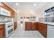 Beautiful open kitchen featuring wood cabinetry, granite counters and natural light at 60 Reyburn Dr, Henderson, NV 89074