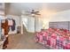 Cozy bedroom features a ceiling fan and stairway entrance at 6240 Clarice Ave, Las Vegas, NV 89107