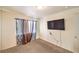 Neutral colored bedroom featuring a large window and television at 6240 Clarice Ave, Las Vegas, NV 89107