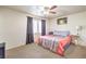 This bedroom features neutral colored walls, a ceiling fan and window at 6240 Clarice Ave, Las Vegas, NV 89107