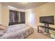 This bedroom features a dark curtain and television set at 6240 Clarice Ave, Las Vegas, NV 89107