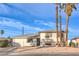 Bright, two-story home featuring desert landscaping and three mature palm trees in front at 6240 Clarice Ave, Las Vegas, NV 89107