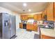 Functional kitchen features tile floors, stainless steel refrigerator, and plenty of counter space at 6240 Clarice Ave, Las Vegas, NV 89107