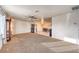 Open-concept living room with neutral carpet, ceiling fan, and views of the dining area at 6240 Clarice Ave, Las Vegas, NV 89107