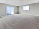 Large finished basement with carpeting, natural light from sliding door and window at 6421 Dinning Ave, Las Vegas, NV 89107