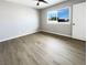 Bright bedroom with wood-look flooring, a ceiling fan, and a window at 6421 Dinning Ave, Las Vegas, NV 89107