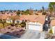 Aerial view of single-story home with desert landscaping and wide driveway at 6424 Old Colonial Way, Las Vegas, NV 89108