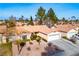 Aerial view of single-story home with desert landscaping and wide driveway at 6424 Old Colonial Way, Las Vegas, NV 89108