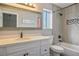 Modern bathroom featuring a vanity with a quartz countertop and a shower and tub at 6424 Old Colonial Way, Las Vegas, NV 89108