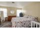 Bright bedroom with a floral bedspread and an antique dresser and mirror at 6424 Old Colonial Way, Las Vegas, NV 89108