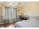 Cozy bedroom with a desk and chair beside a window with patterned curtains at 6424 Old Colonial Way, Las Vegas, NV 89108