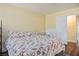 Bedroom featuring neutral tones, a floral bedspread, and a sliding door closet at 6424 Old Colonial Way, Las Vegas, NV 89108