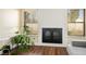 Modern fireplace with white shiplap and black framed glass doors between two windows at 6424 Old Colonial Way, Las Vegas, NV 89108