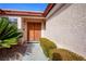 Covered front entryway with double doors and attractive desert landscaping at 6424 Old Colonial Way, Las Vegas, NV 89108