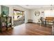 Open living area featuring wood flooring, a sliding glass door, and modern furnishings at 6424 Old Colonial Way, Las Vegas, NV 89108