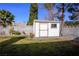 Backyard shed with small window and lush green grass at 6424 Old Colonial Way, Las Vegas, NV 89108